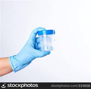 hand in a blue sterile glove holds a plastic container for collecting analyzes, white background
