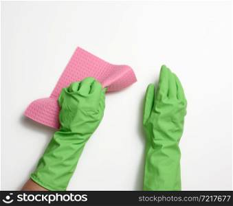 hand in a green rubber glove holds a soft sponge for cleaning surfaces on a white background