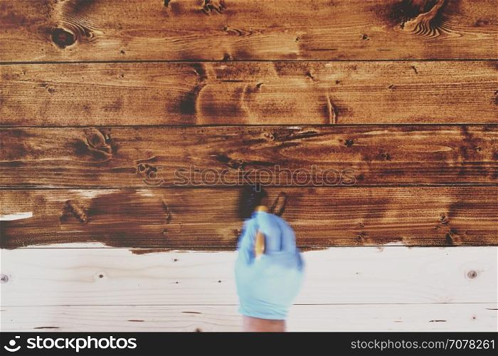 Hand in blue gloves painting wooden furniture in motion blur style. Vintage Tone.&#xA;