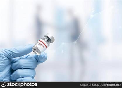 Hand in medical glove holding a vaccine vial
