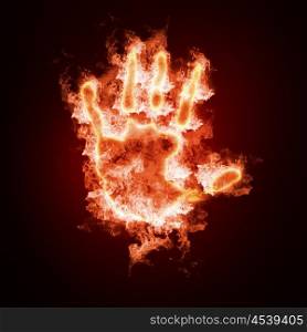 hand in open fire on a black background