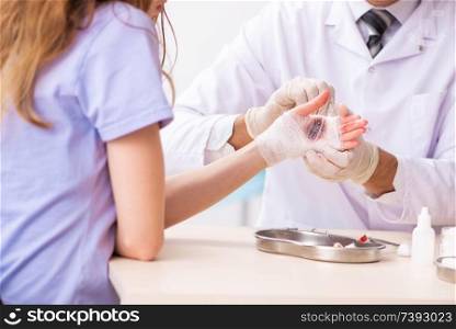 Hand injured woman visiting doctor traumatologist. Hand injured woman visiting doctor traumatologist 