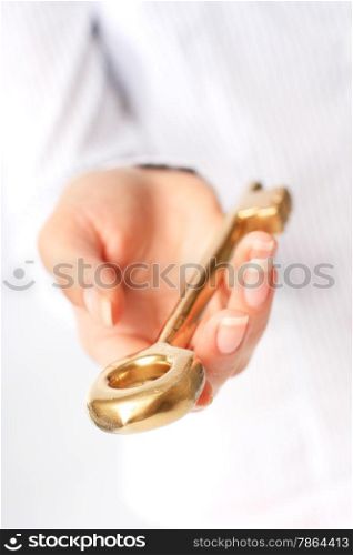 Hand is giving a gold key. Success concept.