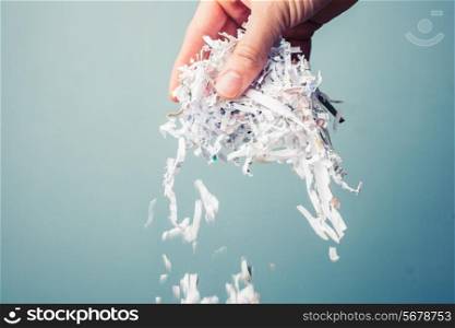 Hand is holding a bunch of shredded paper