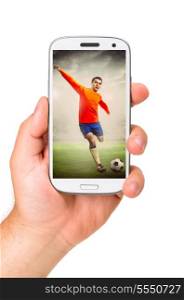hand is holding a modern phone with soccer or football player shooting a ball on screen. mobile soccer