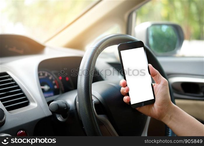 Hand is holding a touch phone with isolated screen in the car.