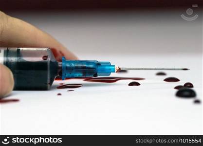 Hand lying on the floor with a Syringe splashing blood, scary theme suicide or overdose isolated on white. Hand lying on the floor with a Syringe splashing blood, scary theme suicide or overdose isolated