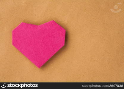 Hand made paper heart on kraft paper as background. Greeting car. Free space for text