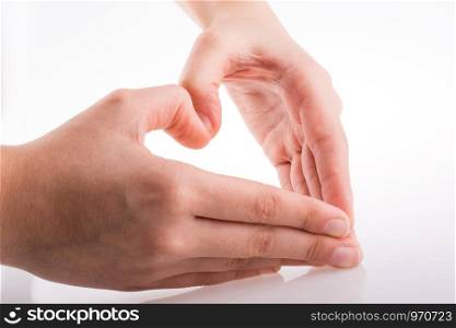 Hand making a heart on a white background