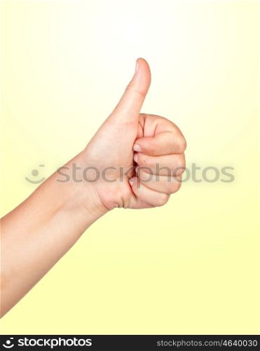 Hand making the sign of Ok isolated on yellow background