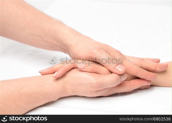 hand massage in the salon of a physiotherapist on a white background closeup