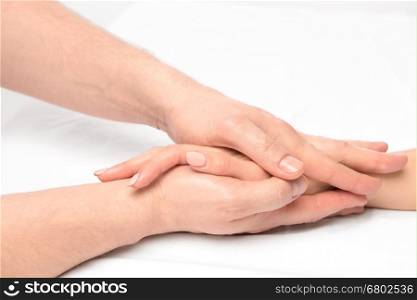 hand massage in the salon of a physiotherapist on a white background closeup