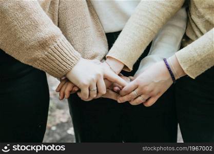 Hand of 3 persons touching together, friendship care and love concepts, copy space