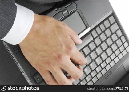 Hand of a man hitting the keyboard of the laptop PC