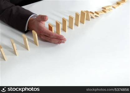 Hand of a man playing with dominoes