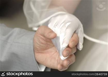 Hand of bridal couple