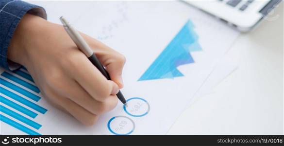 Hand of business man pointing document data graph and chart with pen, marketing and investment, report of statistics profit for financial, economic and growth of finance, management and planning.