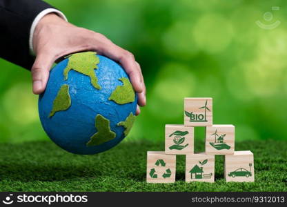 Hand of businessman holding Earth, symbolizing green business utilizing biofuel technology and environmental conservation for sustainable eco-friendly energy for clean future. Alter. Green business utilizing biofuel technology and eco conservation. Alter