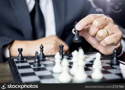 hand of businessman moving chess figure in competition board game for development analysis, strategy idea management or leadership concept