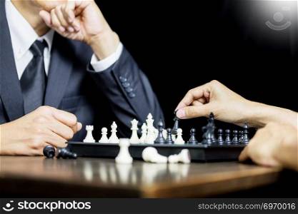 hand of businessman moving chess figure in competition board game for development analysis, strategy idea management or leadership concept