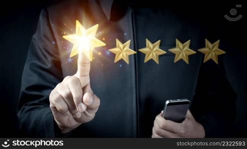 Hand of businessman touching five star symbol to increase rating of company concept
