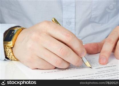 hand of businessman with pen, signing agreement
