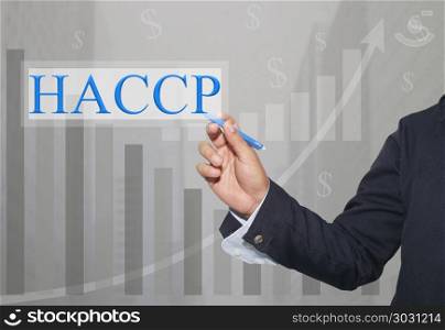 Hand of businessman Write a text of HACCP.. Hand of businessman Write a text of HACCP in concept of presenting ideas in your business.