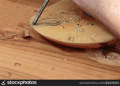 Hand of Carver Carving Wood with Chisel. Carving Wood with Engraver Tool
