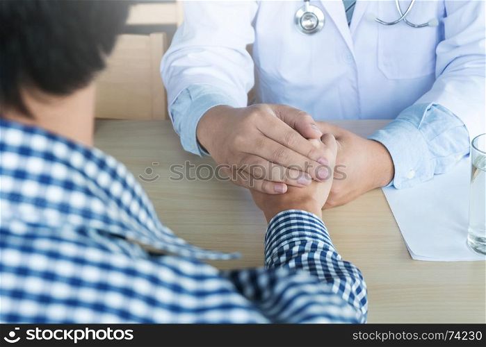 Hand of doctor reassuring his patient