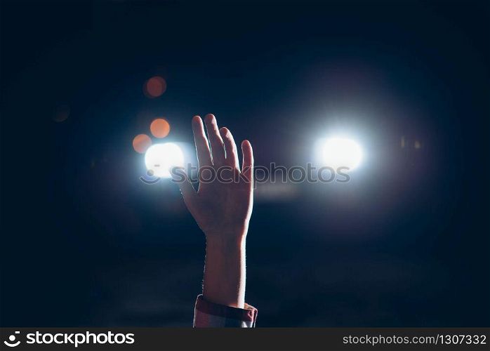 Hand of female victim lasts up in the light of car headlights, maniac is going to finish her. Serial murderer