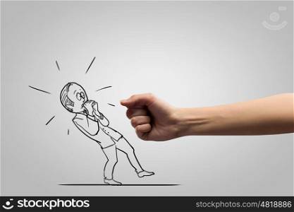 Hand of justice. Close up of human fist fighting with businessman caricature