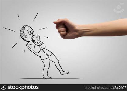 Hand of justice. Close up of human fist fighting with businessman caricature