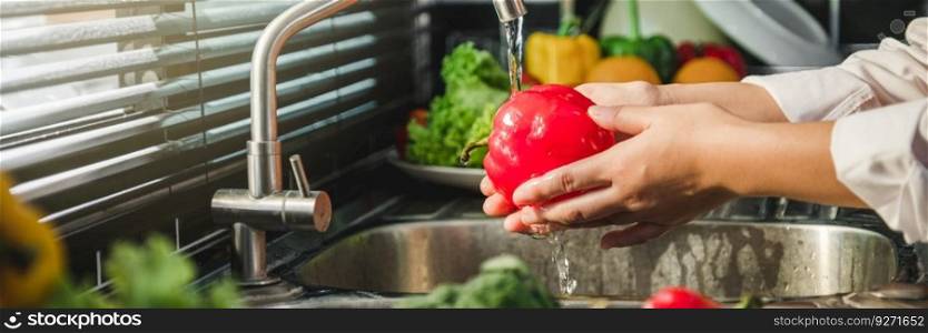 Hand of maid washing tomato fresh vegetables preparation healthy food in kitchen