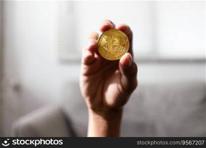 Hand of man holds golden cryptocurrency bitcoin for future lifestyle with virtual electronic money.