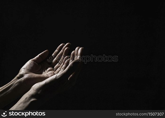 Hand of man while praying for religion. Concept peace and life.