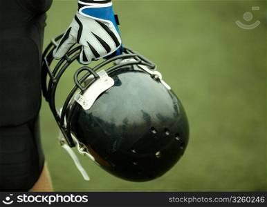 hand of player with black helmet, selective focus