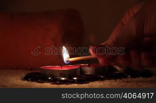 hand of the girl lights candles.