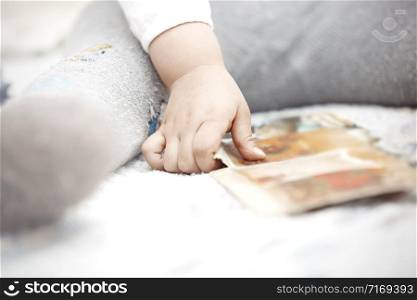 Hand of toddler paying with development card