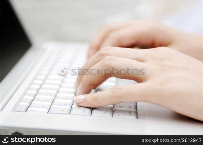 Hand of woman operating keyboard