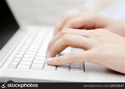 Hand of woman operating keyboard