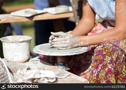 hand on a potter wheel at the fair
