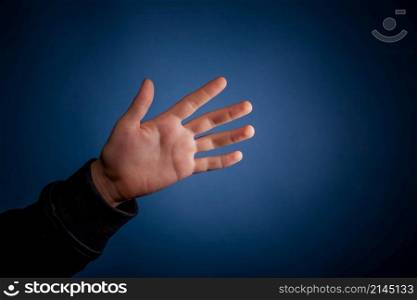 hand on blue background. hand