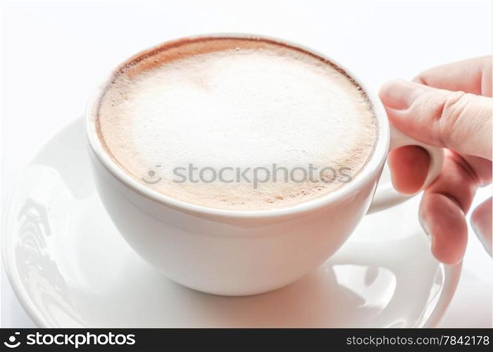 Hand on cup of hot coffee latte
