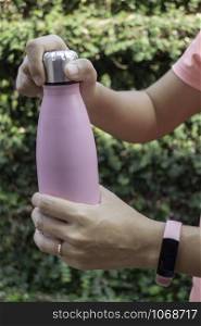 Hand on water bottle for keep temperature, stock photo