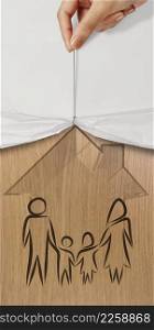 hand open crumpled paper to show hand draw family and house icon on wooden poster as insurance concept