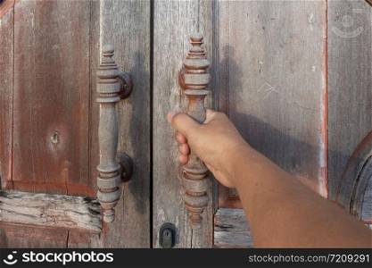 Hand open old vintage wood Door with door lock