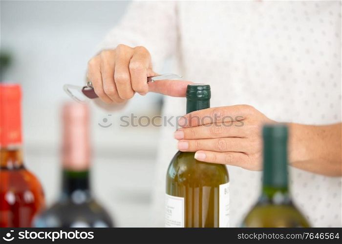 hand opening bottles of wine