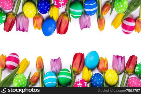 Hand-painted easter eggs with tulips isolated on white background frame with copy space for text. Easter eggs and tulips on white
