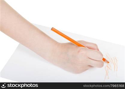 hand paints by orange pencil on sheet of paper isolated on white background