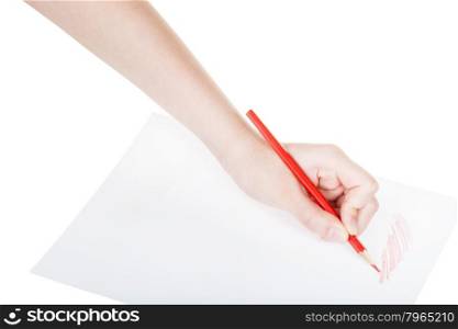hand paints by red pencil on sheet of paper isolated on white background